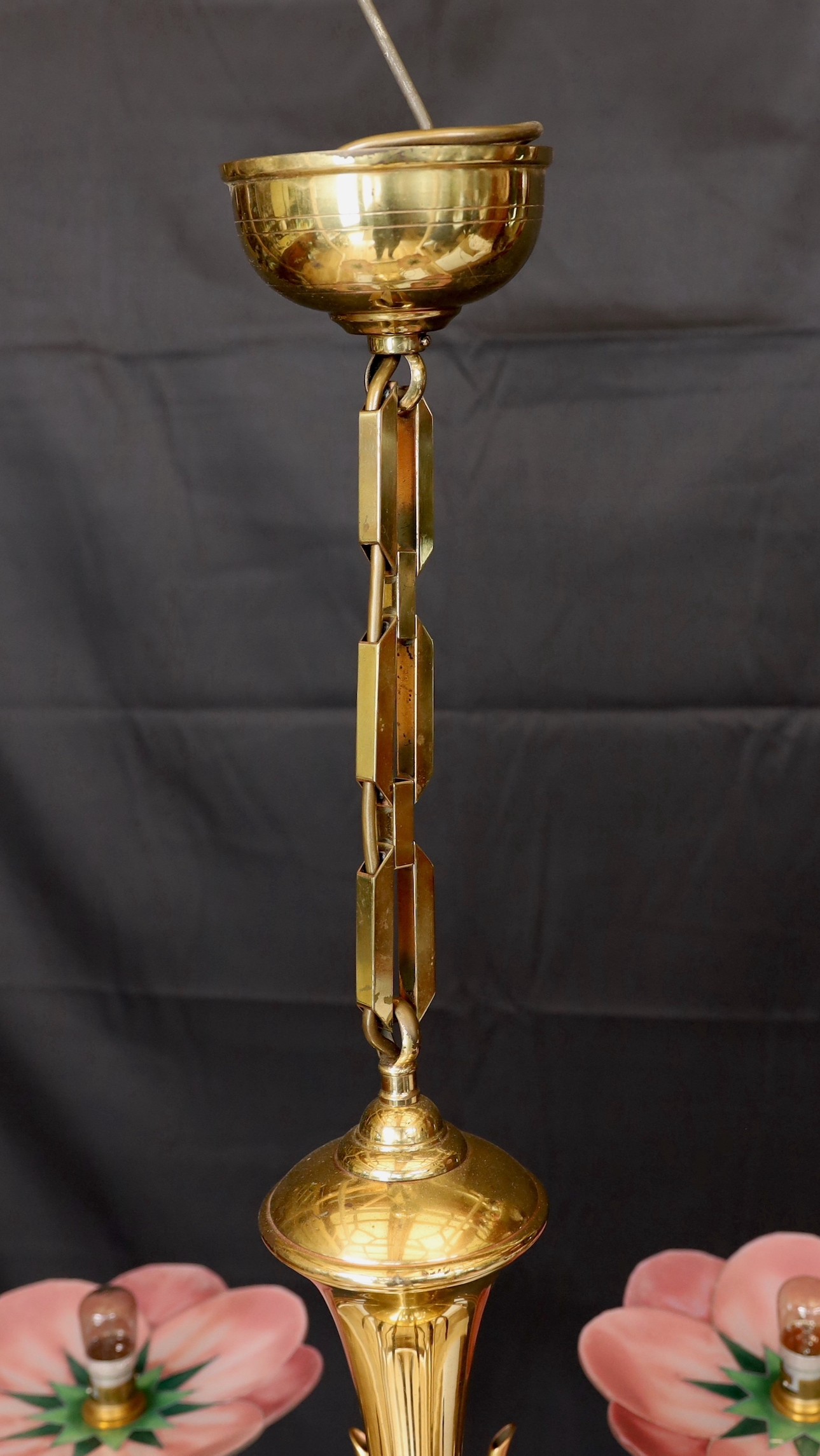 A 1930s French Leys Lurha polished brass four branch light fitting with stylised lotus flower pink glass shades, height 70cm. width 70cm